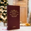 Livre Les règles de la bienséance de Jean Baptise de la Salle posé devant un sapin de Noël